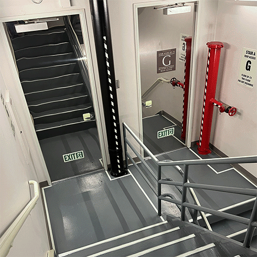 Before and after gif of stairwell photo luminescent lighting install